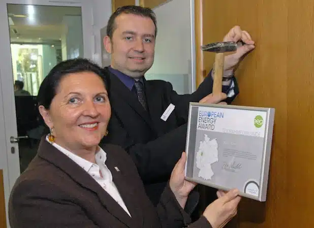 Landrätin Eva Irrgang und Klimaschutzmanager Frank Hockelmann brachten im Kreishaus-Foyer die Urkunde an, mit der die Teilnahme am European Energy Award bescheinigt wird (Foto: Wilhelm Müschenborn/Kreis Soest).