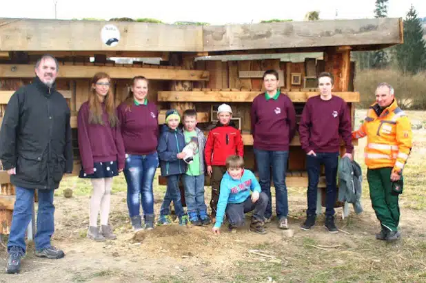 Die NaturRanger freuen sich gemeinsam mit Friedhelm Koch (li.) und Bauhofleiter Thomas Müller (re.) über das XXL-Insektenhotel (Foto: Gemeinde Bestwig).